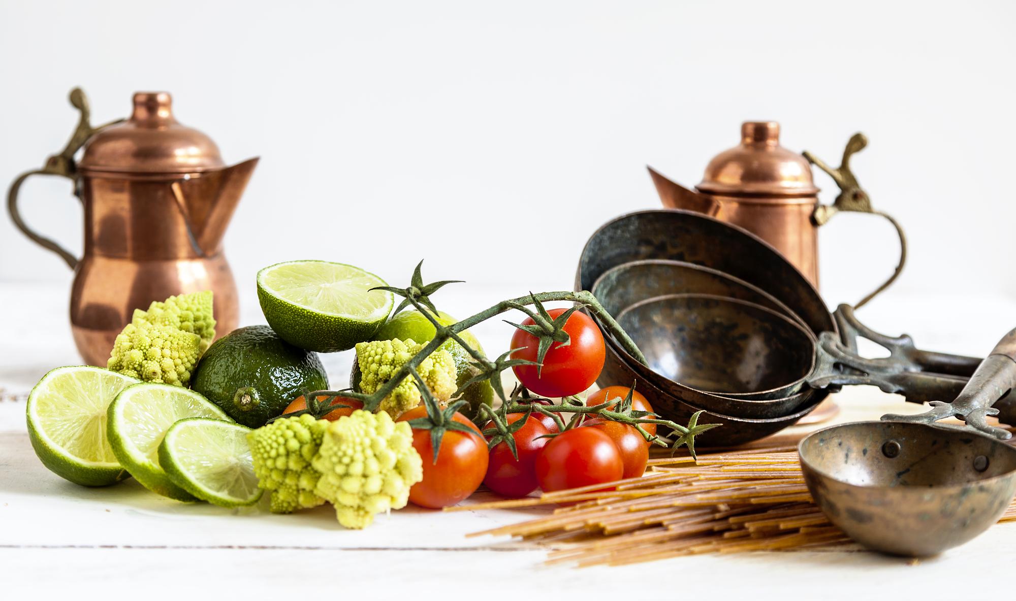 Small artisanal kitchen with copper pans and herbs