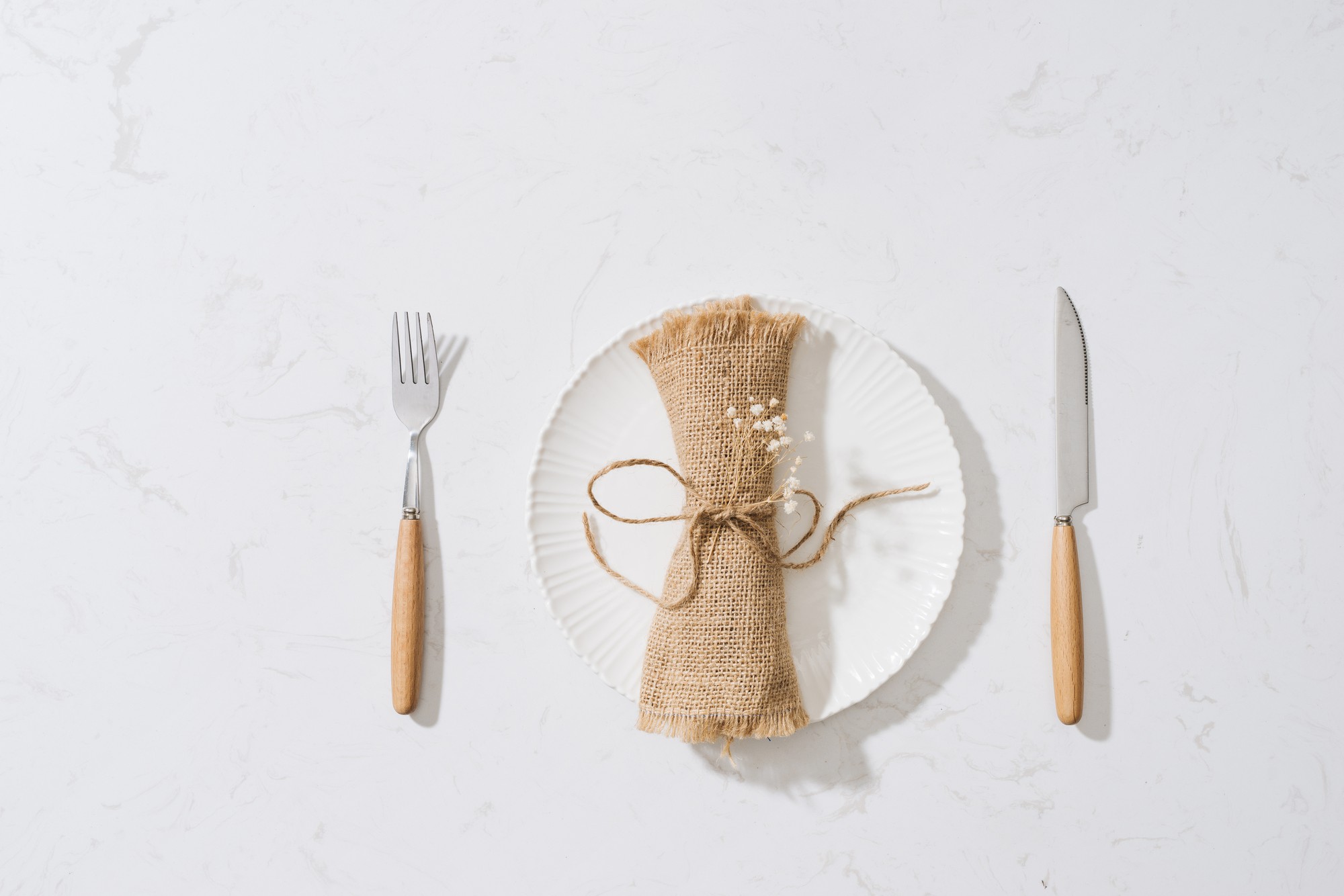 Minimal wooden table setting with linen